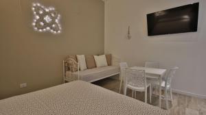 ein Schlafzimmer mit einem Bett, einem Tisch und einem Stuhl in der Unterkunft Casa Levante a 75 mt dalla spiaggia in Monopoli