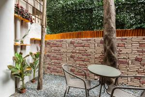 a patio with a table and chairs and a brick wall at Distinguished Flat with Backyard in Sisli in Istanbul