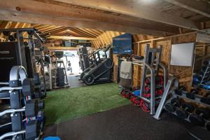 een fitnessruimte met veel apparatuur in een kamer bij Luxury Waterfront Lakehouse Retreat - Piney Woods of East Texas - Lake Palestine in Chandler