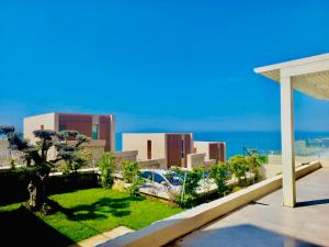 a view from the balcony of a building with a garden at Seaclusion Villa Palase in Palasë