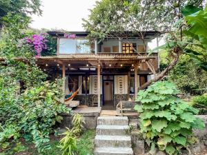 a house with stairs leading up to it at Unicorn Reborn - Peaceful Rentals in San Marcos La Laguna