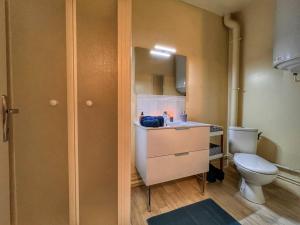 a bathroom with a toilet and a sink and a mirror at Studio ZEN hyper centre Cognac in Cognac