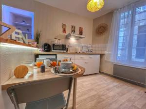 a kitchen with a table with oranges on it at Studio ZEN hyper centre Cognac in Cognac