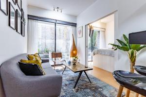 a living room with a couch and a table at San Carlos rentals - Lastarria in Santiago