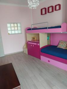 a room with a bunk bed and a table at La casa in piazzetta in Riposto