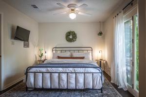 a bedroom with a bed and a ceiling fan at Lush, Enchanting Austin Oasis! in Austin