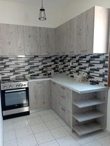 a kitchen with wooden cabinets and a stove top oven at Sofirene II in Batsi +7 photos