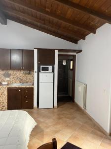 a kitchen with a white refrigerator and a stove at B&B La cas' d'Alfonz' in Sulmona