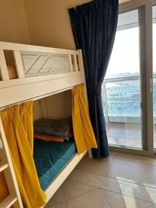 a bunk bed in a room with a window at The Mood House I Dubai Marina in Dubai