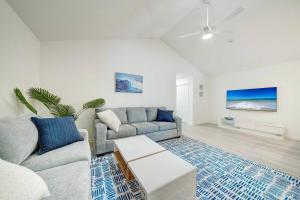 a living room with a couch and a table at Lagoon 2623 by Nautical Properties in Panama City Beach