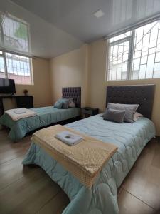 Postel nebo postele na pokoji v ubytování Roma House N- suite Campin Movistar Ministerios Simón Bolivar