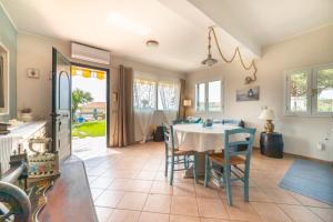 a kitchen and dining room with a table and chairs at Chez Elle in Imperia