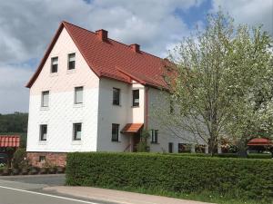 a large white house with a red roof at Rhön - Nestchen in Unteralba