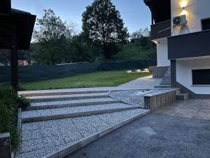 a set of stone steps leading to a house at Vila s bazenom deluxe - GTI in Zagreb