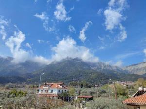 a view of a mountain with clouds in the sky at Вила Елена-Villa Elena in Skala Potamias
