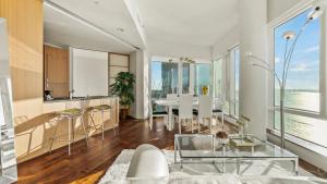 a kitchen and living room with a table and chairs at Luxurious 4 BR Penthouse in NYC in New York