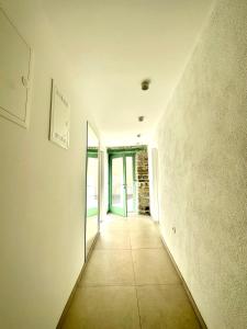 an empty hallway with a door in a building at Damir Skomina Apartments in Koper