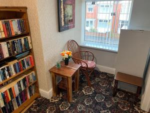 a room with a table and a chair and a window at The Northdale Hotel Ltd in Skegness