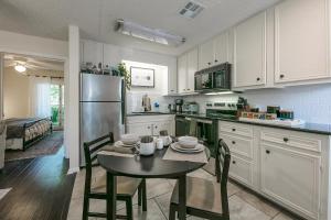 a kitchen with a table and a refrigerator at Lush, Enchanting Austin Oasis! in Austin