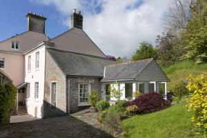 a white house with a gray roof at Bowden Retreats in Dartmouth