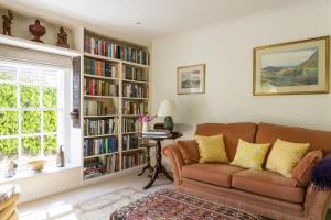 a living room with a couch and bookshelves at Bowden Retreats in Dartmouth