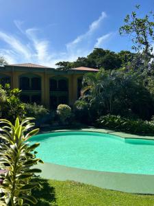 a swimming pool in front of a house at Trapp Family Country Inn in San Antonio