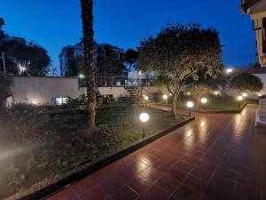 a park at night with lights on the sidewalk at Sun Terrace Sorrento in Sorrento