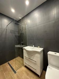 a bathroom with a sink and a shower and a toilet at Lux apartments Top center in Sofia