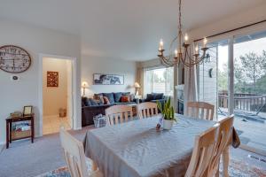 a dining room and living room with a table and chairs at Charming Redmond Townhome with Resort Amenities in Redmond