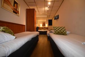 Postel nebo postele na pokoji v ubytování ITC Hotel