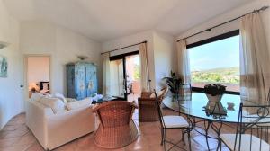 a living room with a white couch and a glass table at Monica Luxury House in Porto Cervo +14 photos
