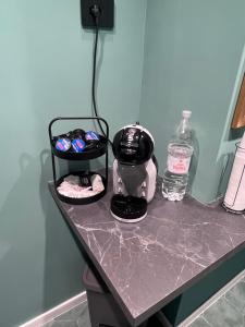 a counter with a mixer and a bottle of water at Gioia Home in Pompei