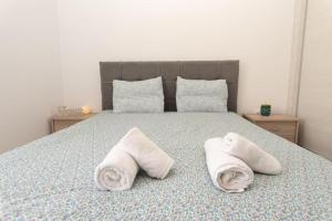 a bedroom with a bed with towels on it at Fully equipped flat in Piraeus (Erm_C7) in Piraeus