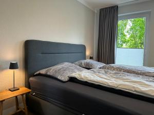 a bedroom with a large bed and a window at Steinweg 7 Ferienwohnung in Kassel
