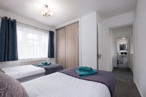 um quarto de hotel com duas camas e uma janela em 6bed Perfect stay! Contractors welcome! em Peterborough