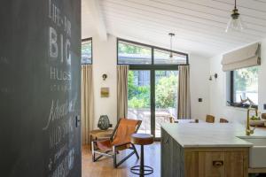 a kitchen with a chalkboard on the wall at Den in the Woods in Slapton