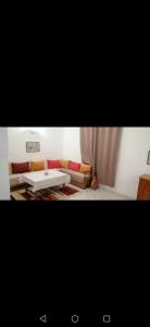 a living room with a couch and a table at Younes résidence 3 in Asilah