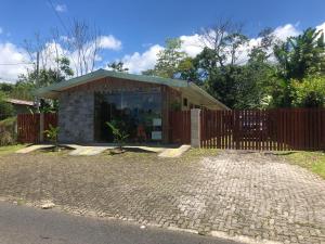 a small house with a wooden fence in front of it at Le Petit Hotel in Fortuna