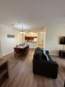 a living room with a couch and a dining room at Florida Vacation Condo - No Resort Fees in Kissimmee