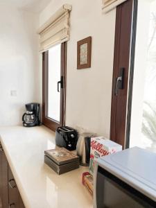 a kitchen with a counter with a tv and a window at Leo's Paradise in Protaras