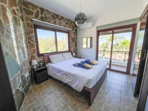 a bedroom with a bed and a stone wall at Leo's Paradise in Protaras