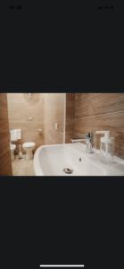 a bathroom with a white sink and a toilet at La casetta di carmé in Naples