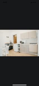 a kitchen with white cabinets and a table and chairs at La casetta di carmé in Naples +31 photos