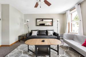 a living room with a couch and a table at WALK to West Point Academy! Charming 2 bdrm Apt overlooking Main Street! in Highland Falls