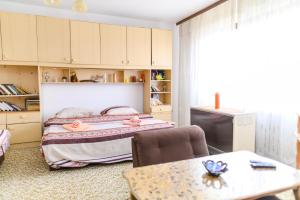 a bedroom with a bed and a table at Vila Vojvođanka in Soko Banja