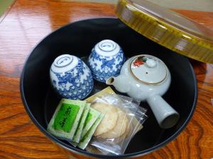 a black bowl filled with chinese items in a table at Minshuku Kuwataniya - Vacation STAY 96480v in Takayama