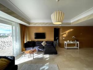 a living room with a couch and a table at Tour Végétale CFC Anfa Luxury in Casablanca