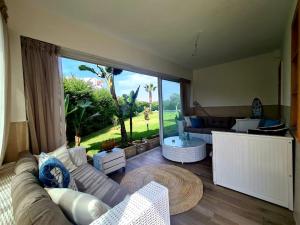 a living room with a couch and a table at Chill and vibe house in Sidi el Haj Bou Derbala