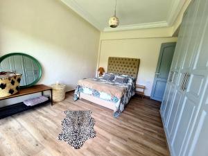 - une chambre avec un lit, une commode et un miroir dans l'établissement Chill and vibe house, à Sidi el Haj Bou Derbala
