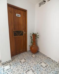 a room with a door and a vase on the floor at Aldea Bella Boutique in Doradal